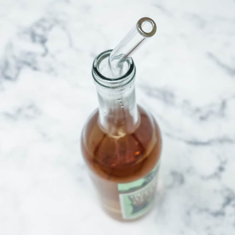 Glass bottle with straw